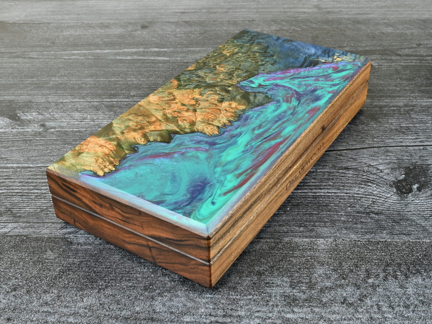 This Delver's Kit Dice Box features a Patagonian rosewood core and an Bluegreen maple burl top veneer with blue, purple, and fuchsia resin. D&D ttrpg.