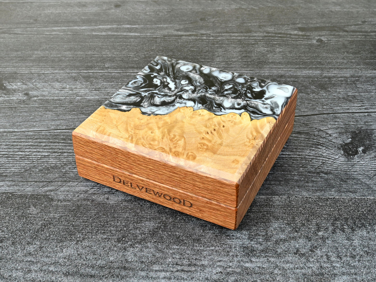 This Little Delver Dice Box features a lacewood core and a maple burl top veneer with black, white, and silver resin. D&D ttrpg.