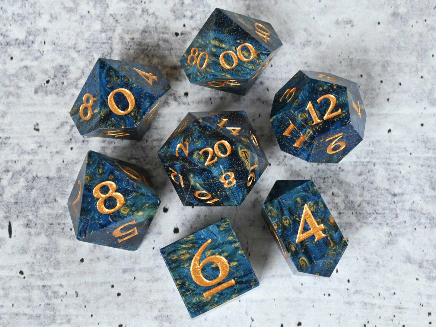 Blue dye stabilized black ash burl wood dice set with gold painted numbers for dnd ttrpg