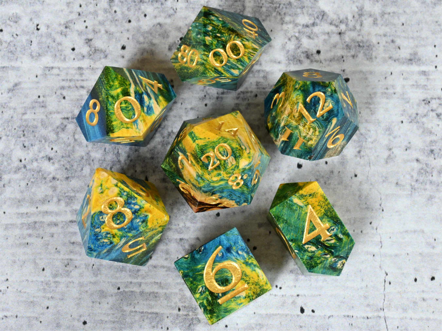 Yellow, green and blue dye stabilized box elder burl wood dice set with gold painted numbers for dnd ttrpg
