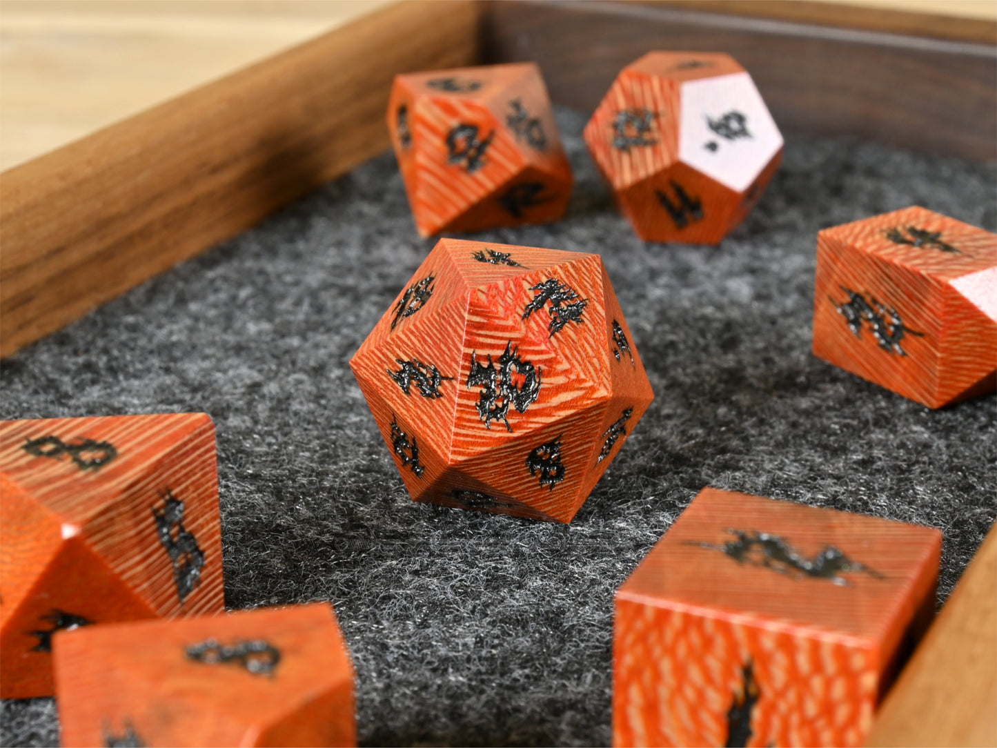 Orange dye stabilized sycamore wood dice set.