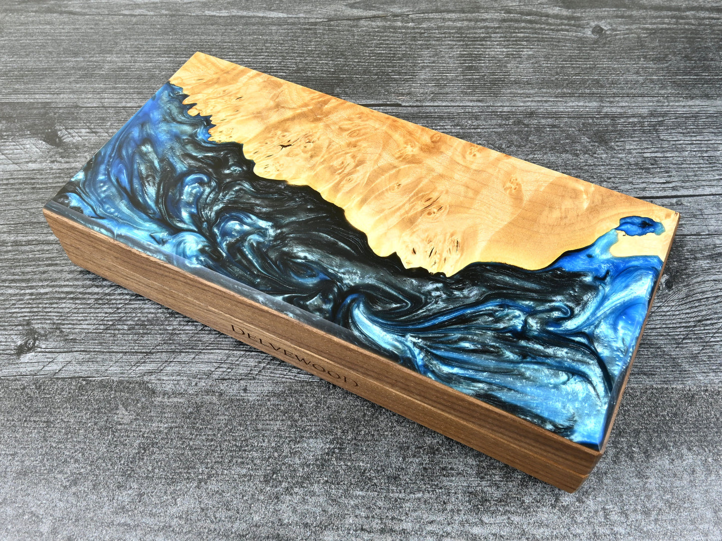 This Delver's Kit Dice Box features a walnut core and a maple burl top veneer with blue and black resin.  D&D ttrpg.