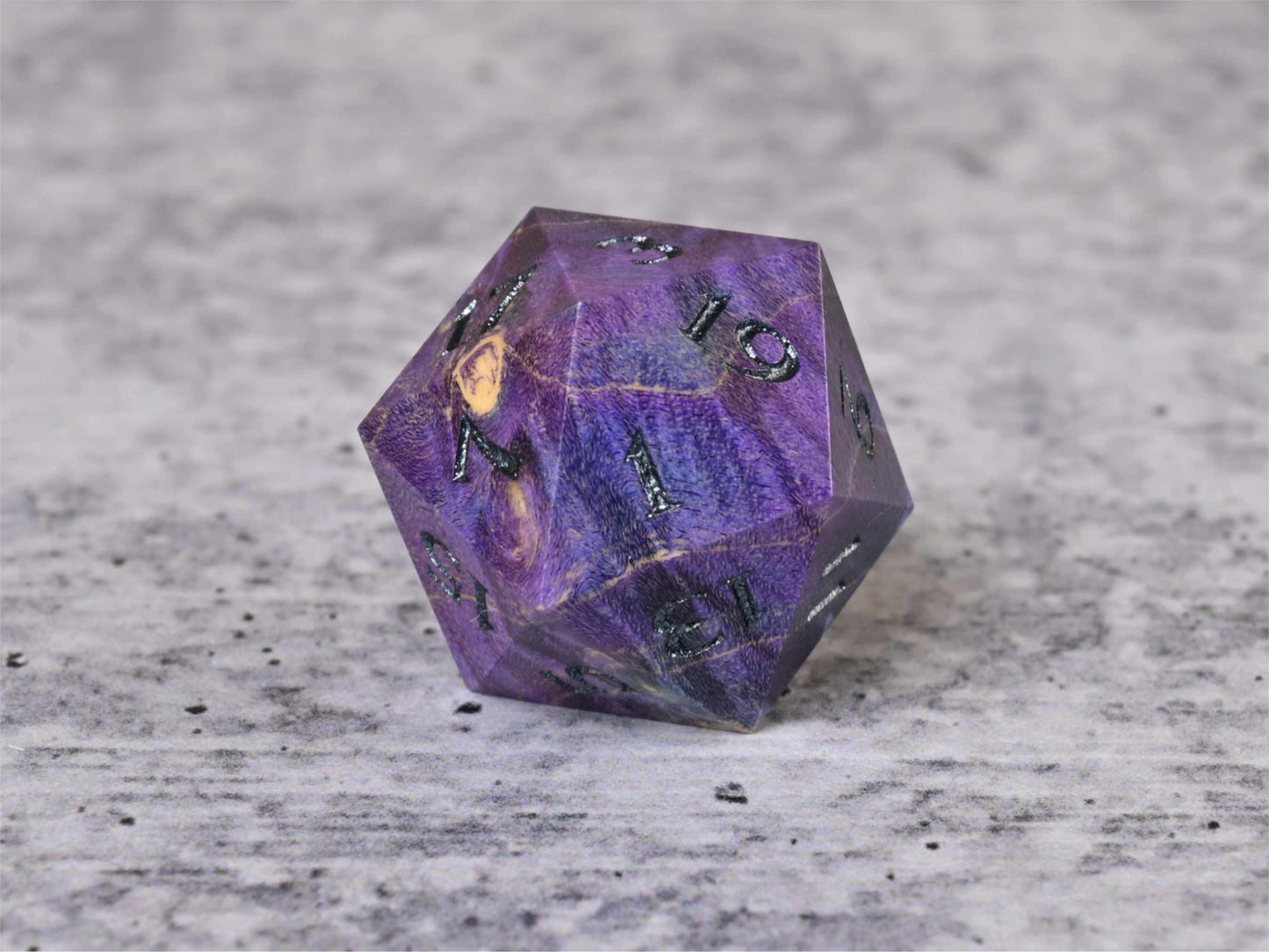 Purple and blue dye stabilized box elder burl wood d20 with dark sliver painted numbers for dnd ttrpg