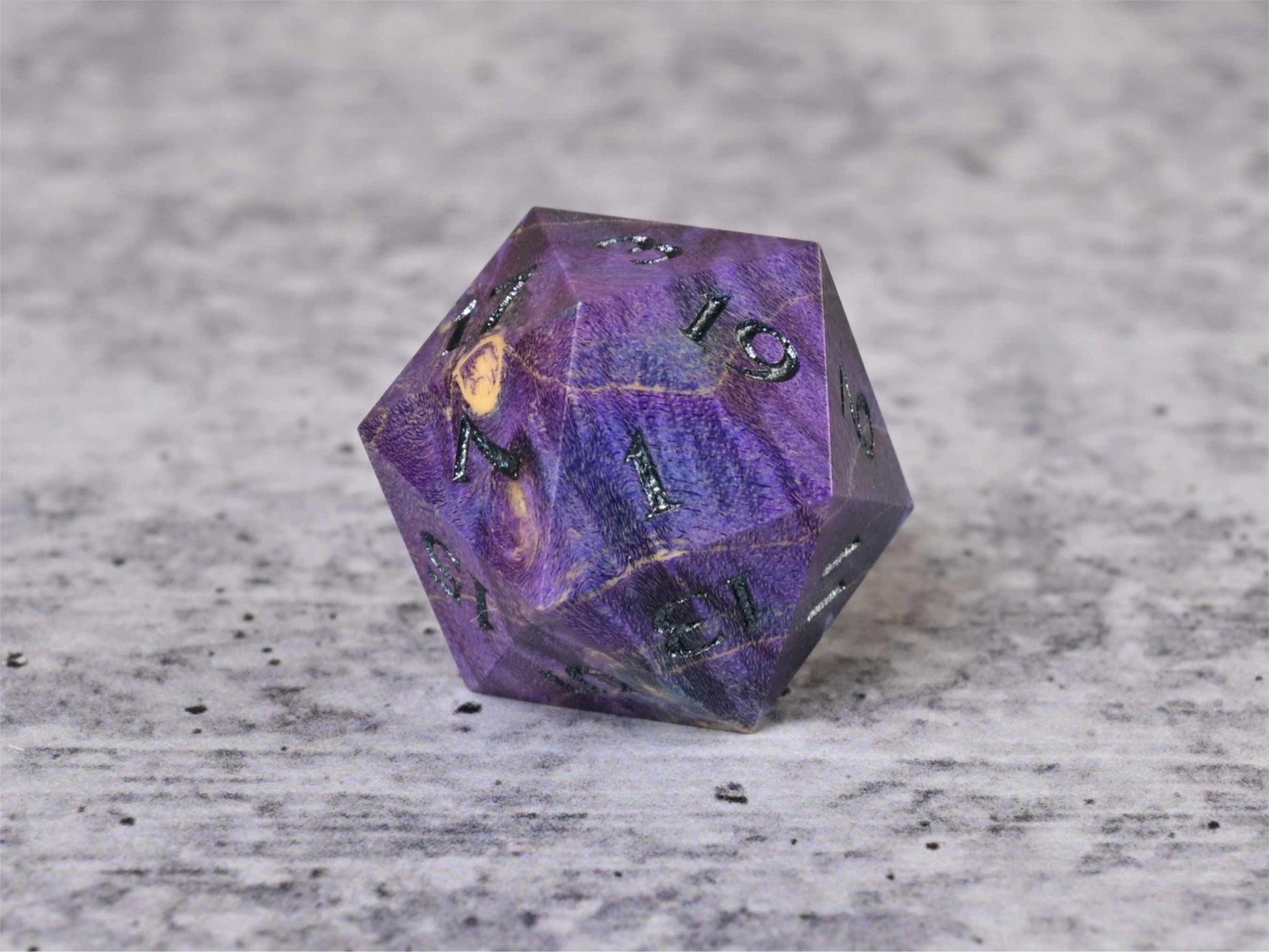 Purple and blue dye stabilized box elder burl wood d20 with dark sliver painted numbers for dnd ttrpg