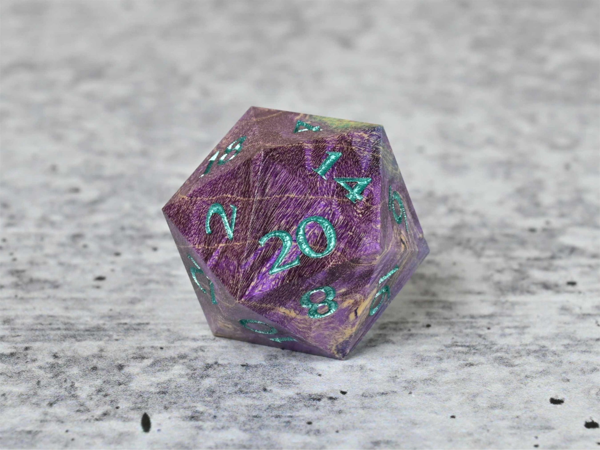 Purple and teal dye stabilized box elder burl wood d20 with teal painted numbers for dnd ttrpg
