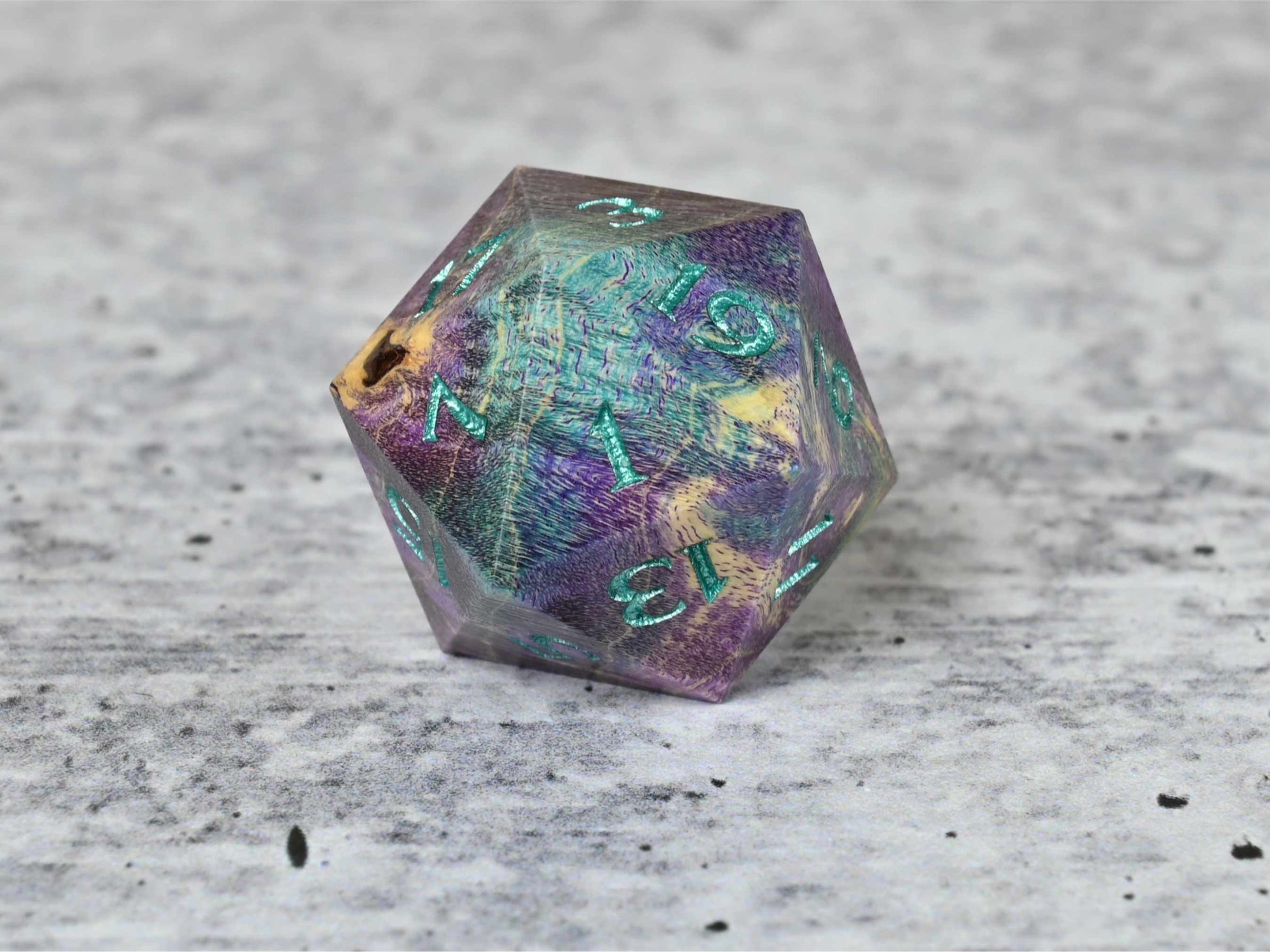 Purple and teal dye stabilized box elder burl wood d20 with teal painted numbers for dnd ttrpg