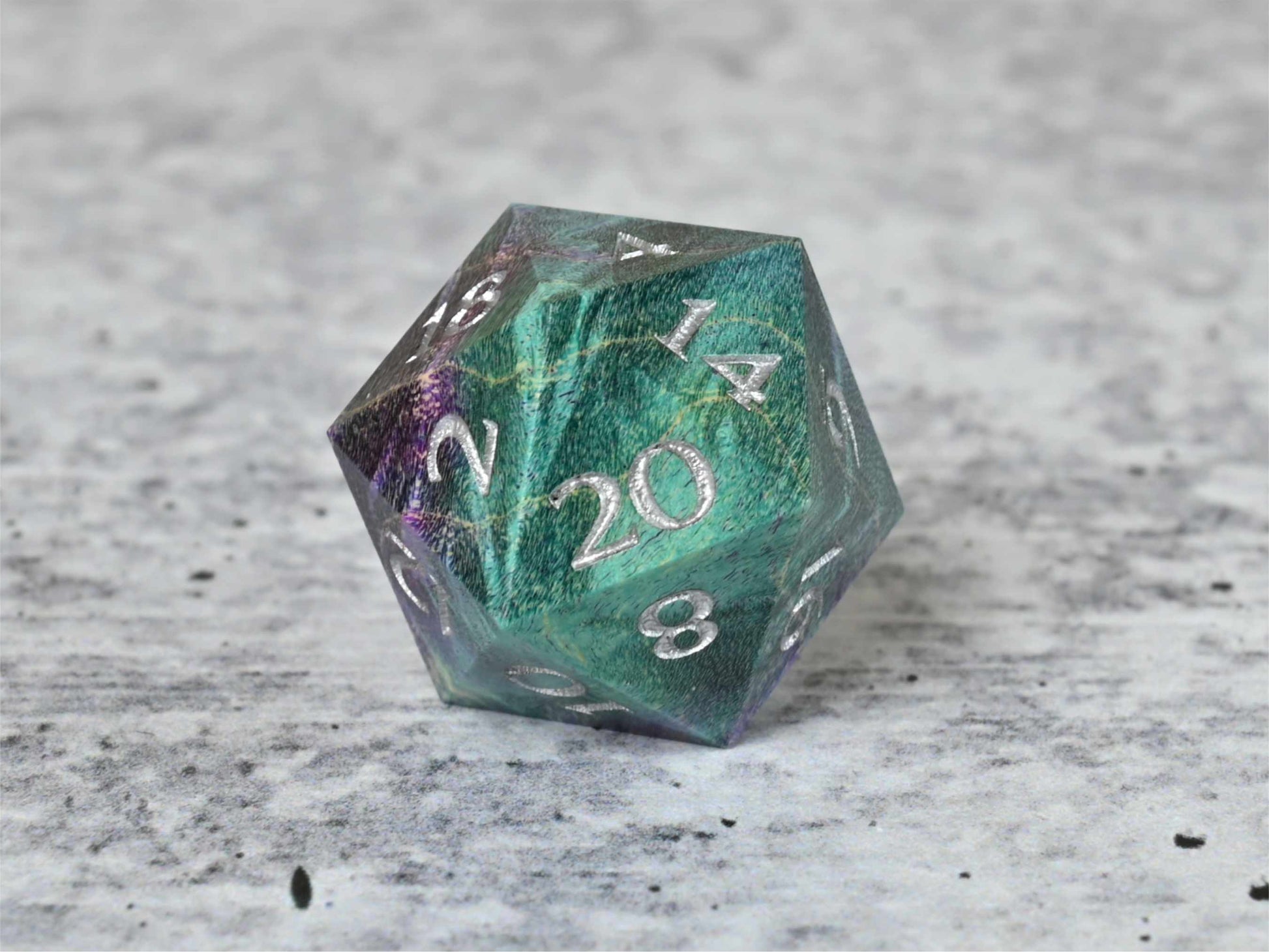 Teal and purple dye stabilized box elder burl wood d20 with silver painted numbers for dnd ttrpg