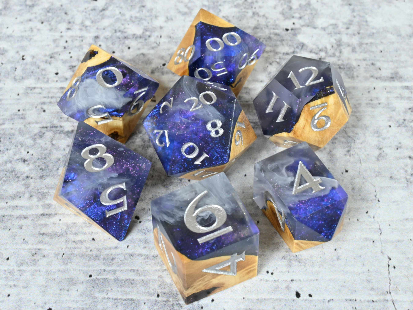Cloud Nebula Buckeye burl wood and resin dice set with silver painted numbers for dnd tabletop rpg