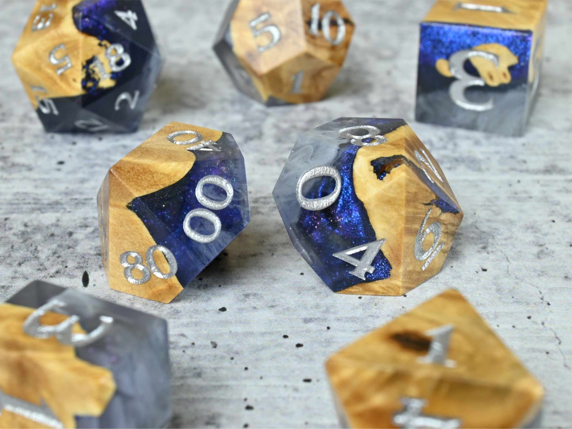 Cloud Nebula Buckeye burl wood and resin dice set with silver painted numbers for dnd tabletop rpg
