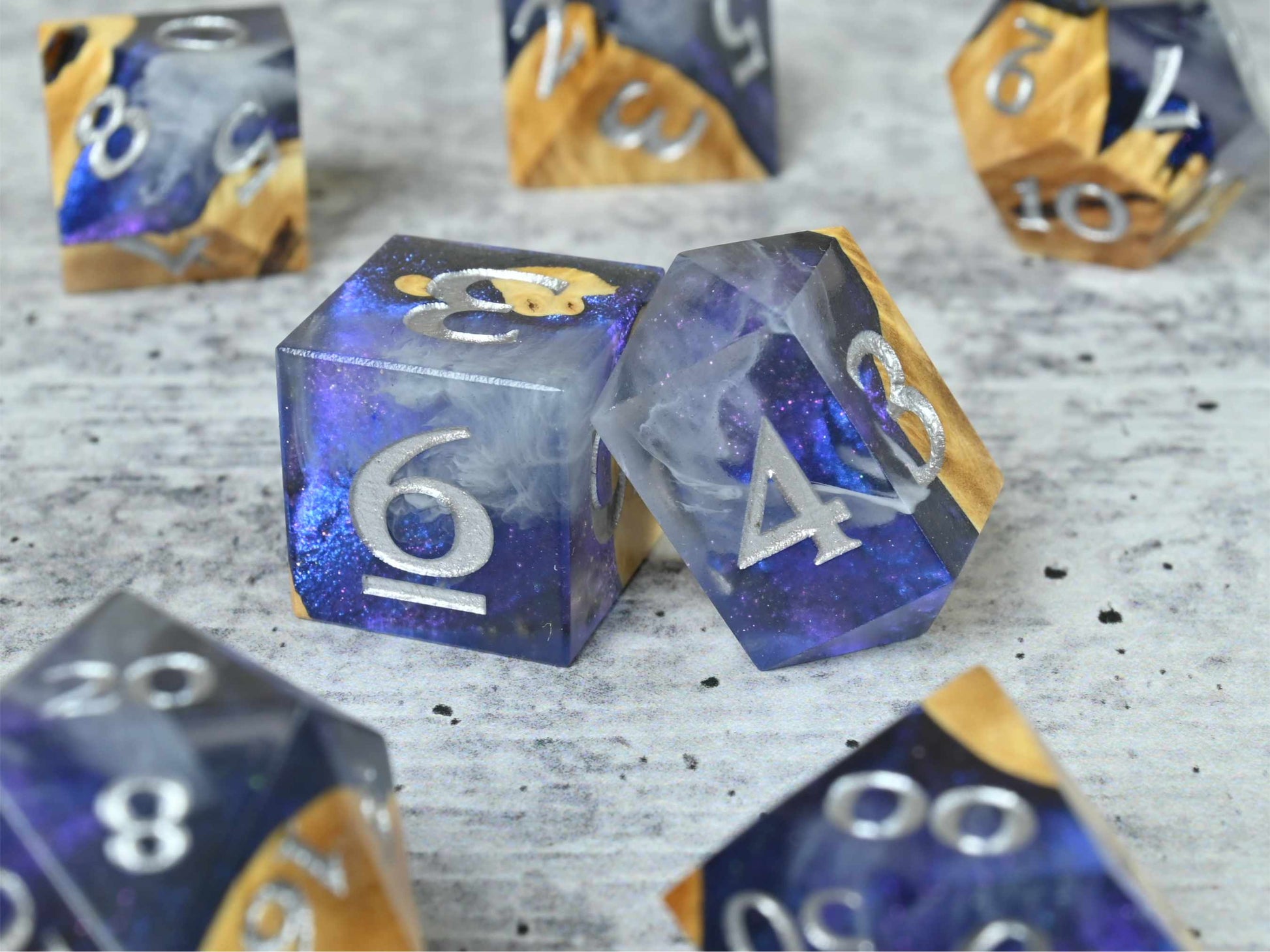 Cloud Nebula Buckeye burl wood and resin dice set with silver painted numbers for dnd tabletop rpg
