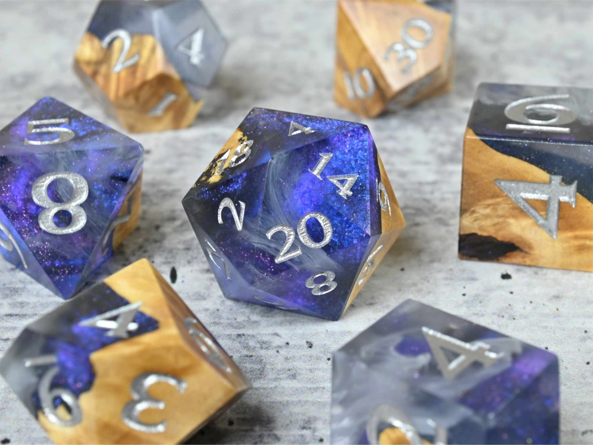 Cloud Nebula Buckeye burl wood and resin dice set with silver painted numbers for dnd tabletop rpg