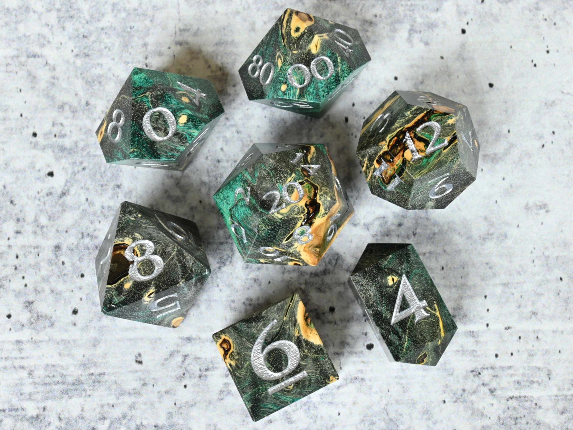 Black and teal dye stabilized buckeye burl wood dice set with silver painted numbers for dnd ttrpg