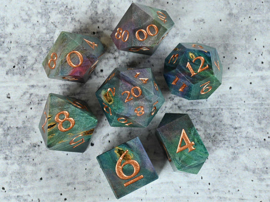 Teal, blue and pink dye stabilized buckeye burl wood dice set with bronze painted numbers for dnd ttrpg