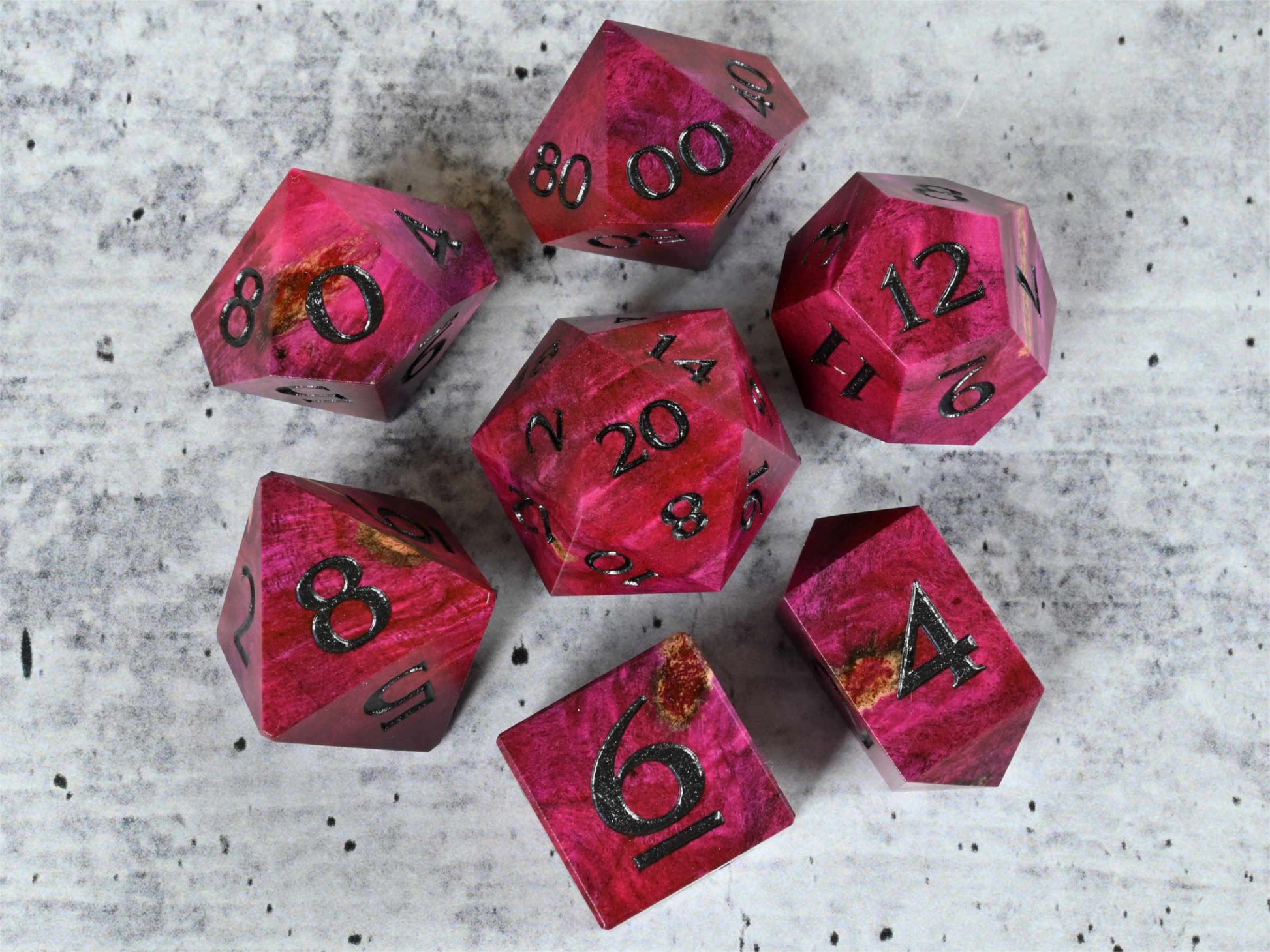 Pink dye stabilized buckeye burl wood dice set with black painted numbers for dnd ttrpg