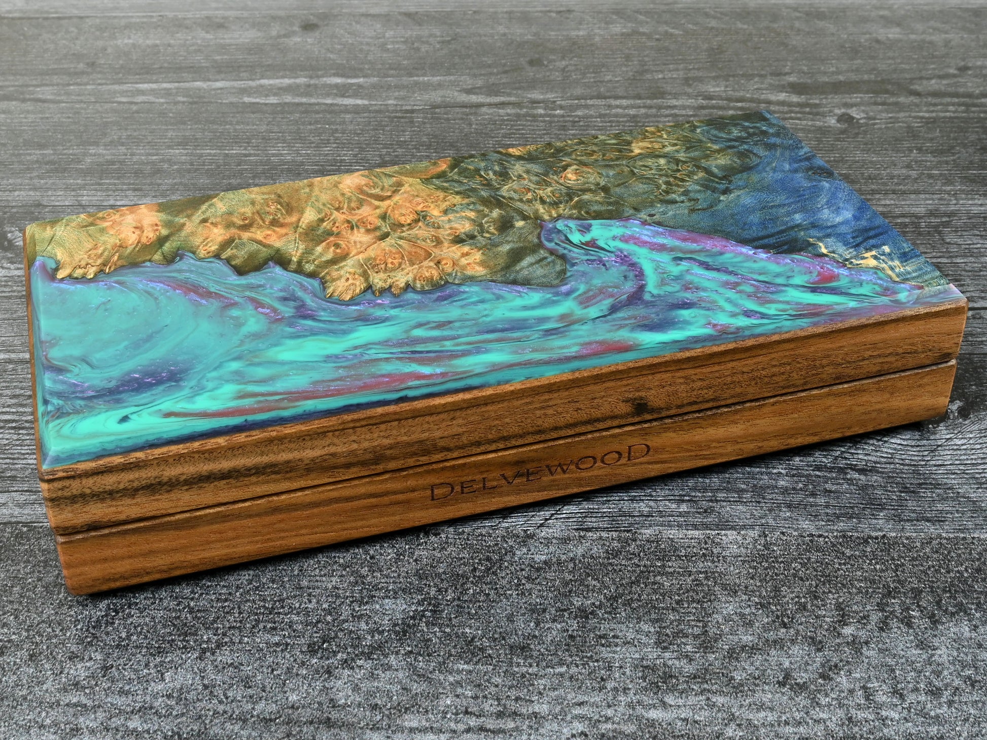 This Delver's Kit Dice Box features a Patagonian rosewood core and an Bluegreen maple burl top veneer with blue, purple, and fuchsia resin. D&D ttrpg.
