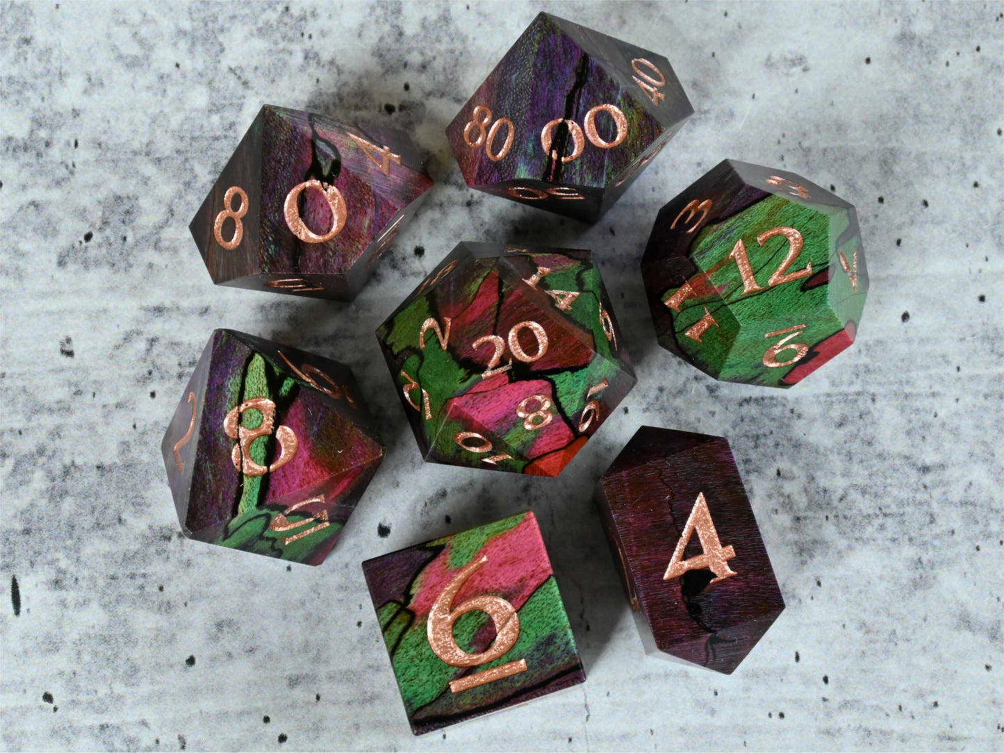 Purple, teal and pink dye stabilized spalted maple wood dice set with rose gold painted numbers for dnd ttrpg