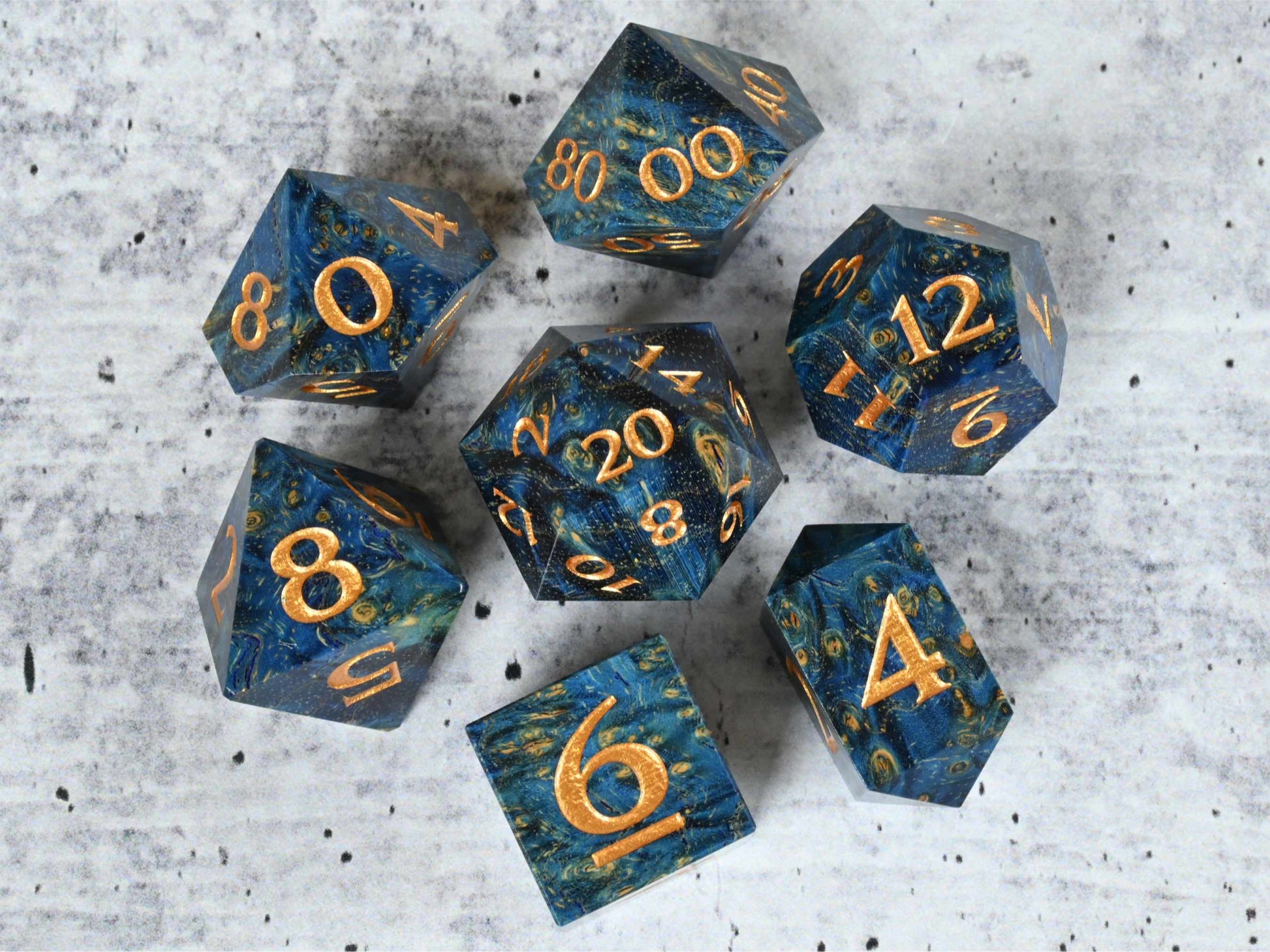 Blue dye stabilized black ash burl wood dice set with gold painted numbers for dnd ttrpg