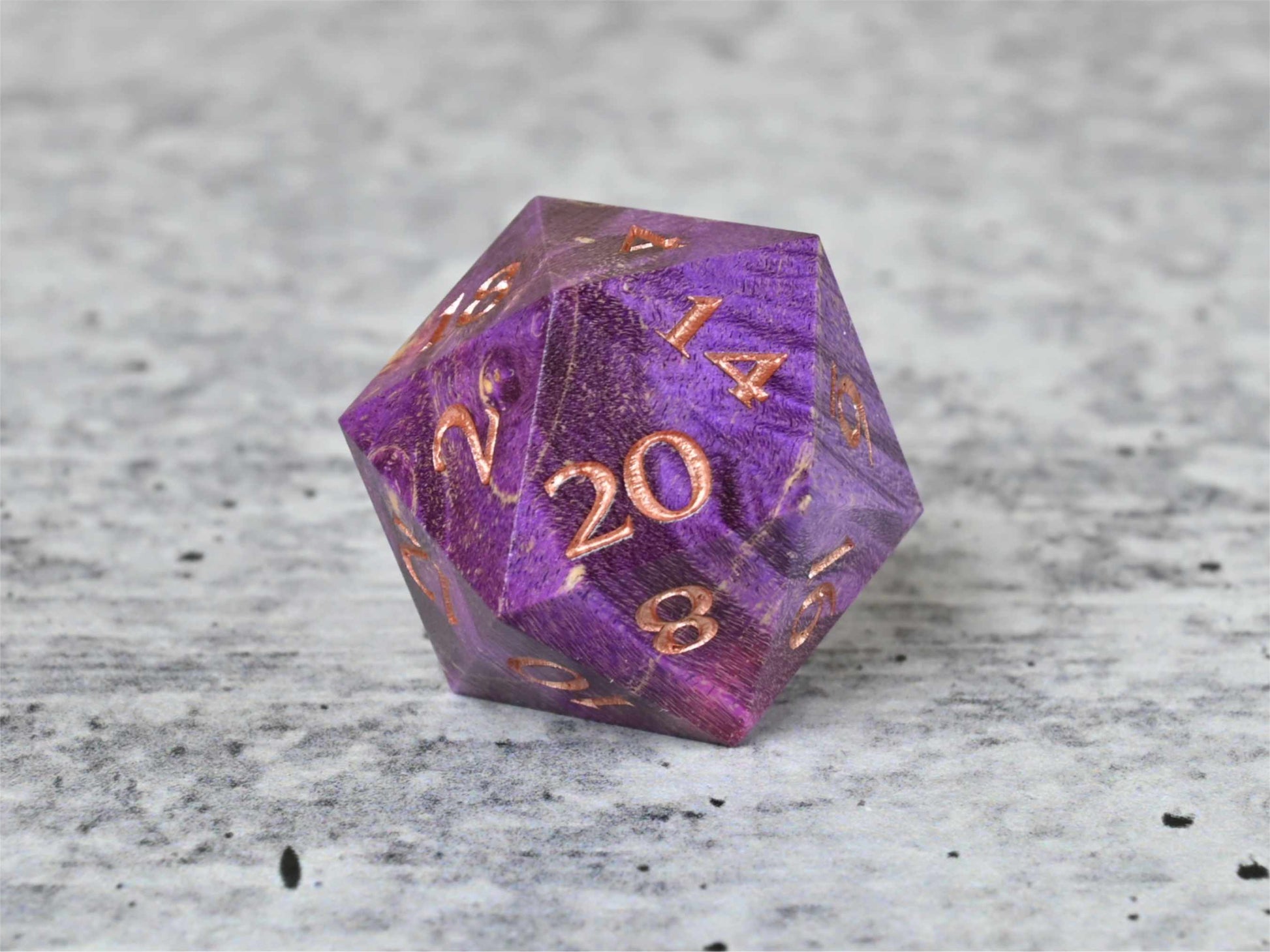Purple and pink dye stabilized box elder burl wood d20 with rose gold painted numbers for dnd ttrpg