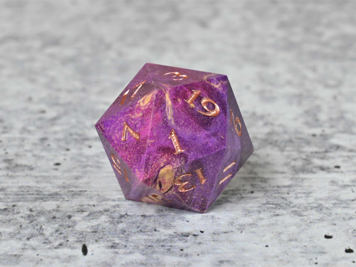 Purple and pink dye stabilized box elder burl wood d20 with rose gold painted numbers for dnd ttrpg