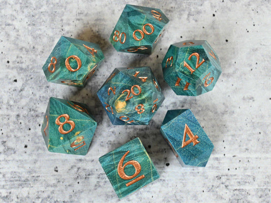 Blue and teal dye stabilized box elder burl wood d20 with bronze painted numbers for dnd ttrpg