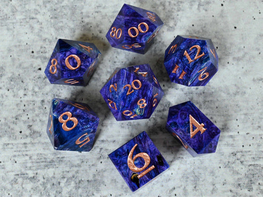 Purple and blue dye stabilized black ash burl wood dice set with rose gold painted numbers for dnd ttrpg