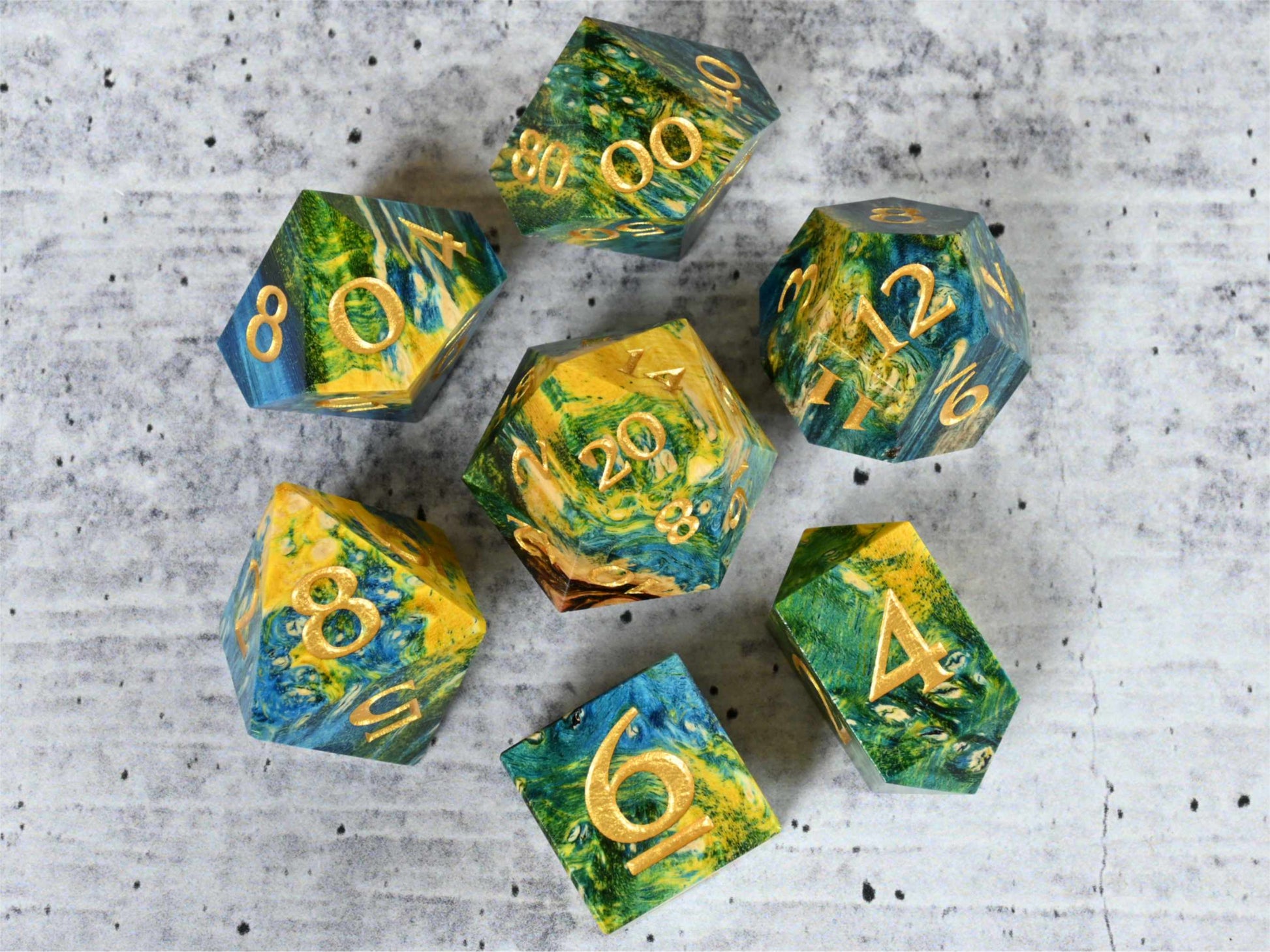Yellow, green and blue dye stabilized box elder burl wood dice set with gold painted numbers for dnd ttrpg