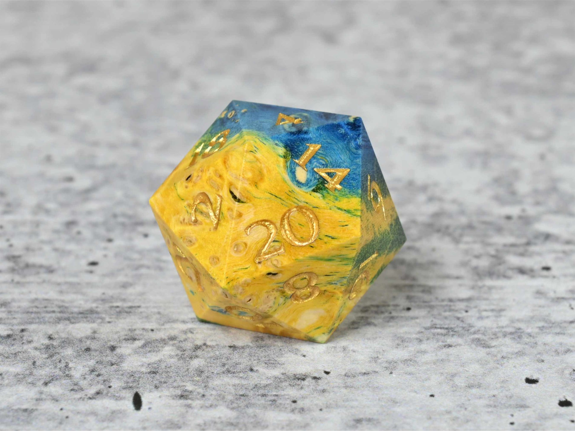 Yellow, green and blue dye stabilized box elder burl wood d20 with gold painted numbers for dnd ttrpg