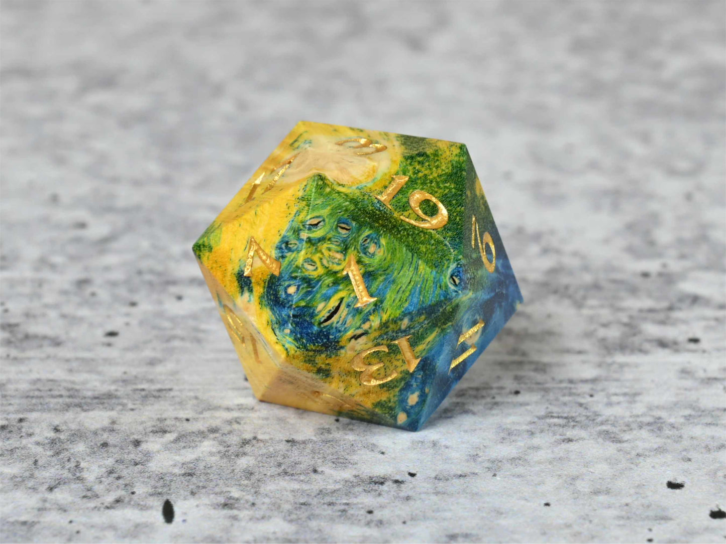 Yellow, green and blue dye stabilized box elder burl wood d20 with gold painted numbers for dnd ttrpg