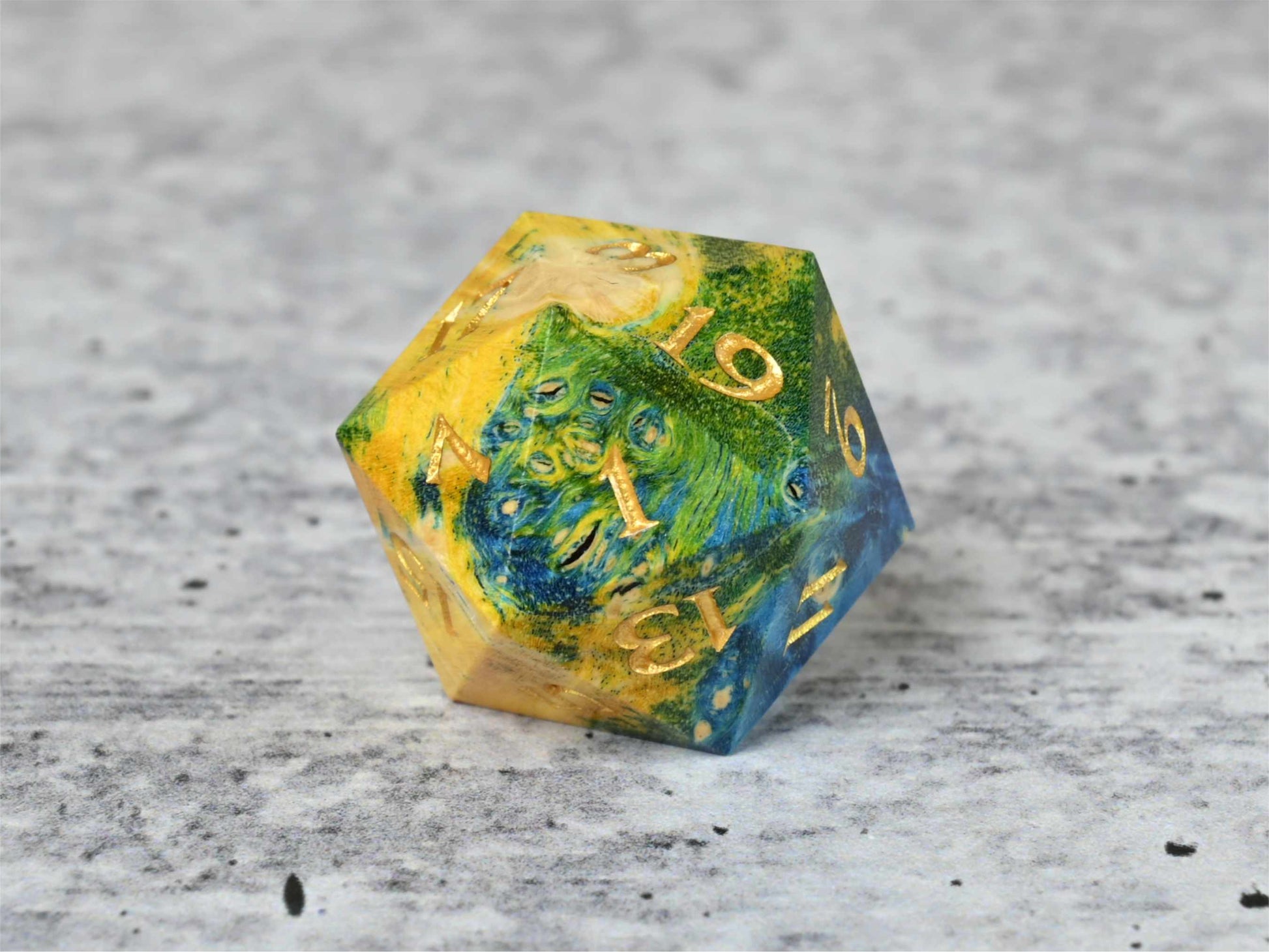 Yellow, green and blue dye stabilized box elder burl wood d20 with gold painted numbers for dnd ttrpg