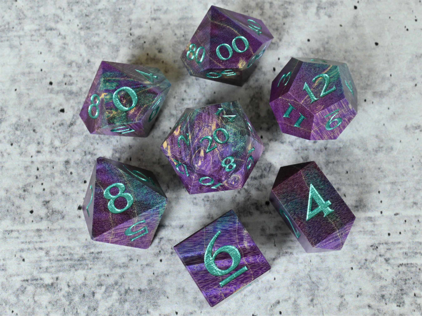 purple and teal dye stabilized box elder burl wood dice set with teal painted numbers for dnd ttrpg