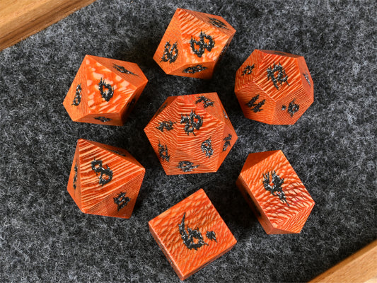 Orange dye stabilized sycamore wood dice set.