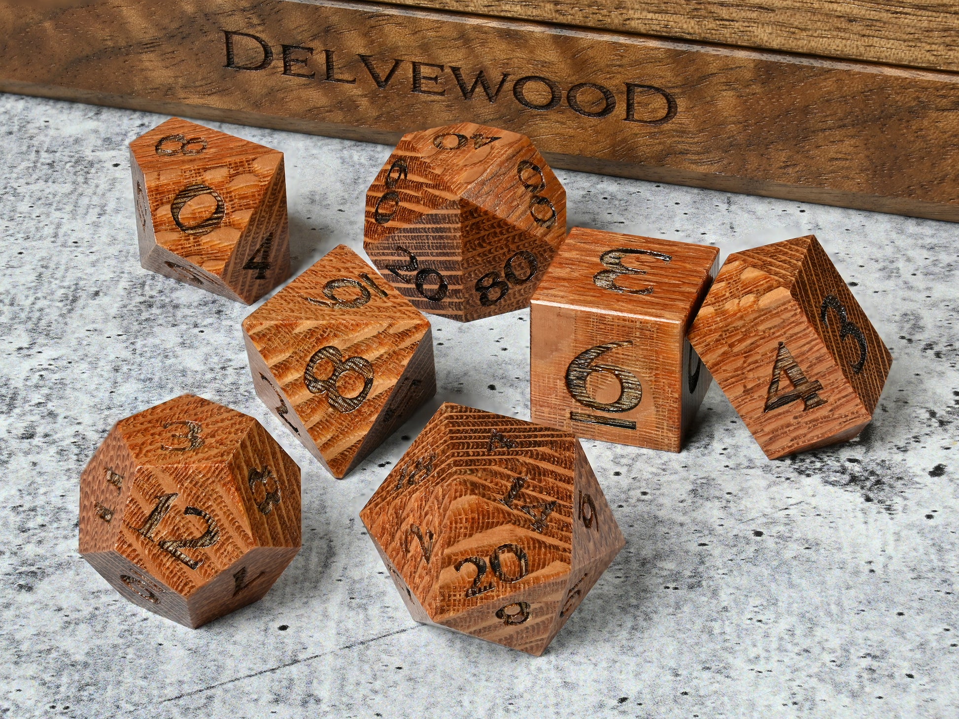 leopardwood dice set for dnd rpg tabletop gaming in front of Delvewood delver's kit dice box.