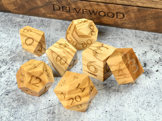 Olivewood dice set for dnd rpg tabletop gaming in front of Delvewood delver's kit dice box.