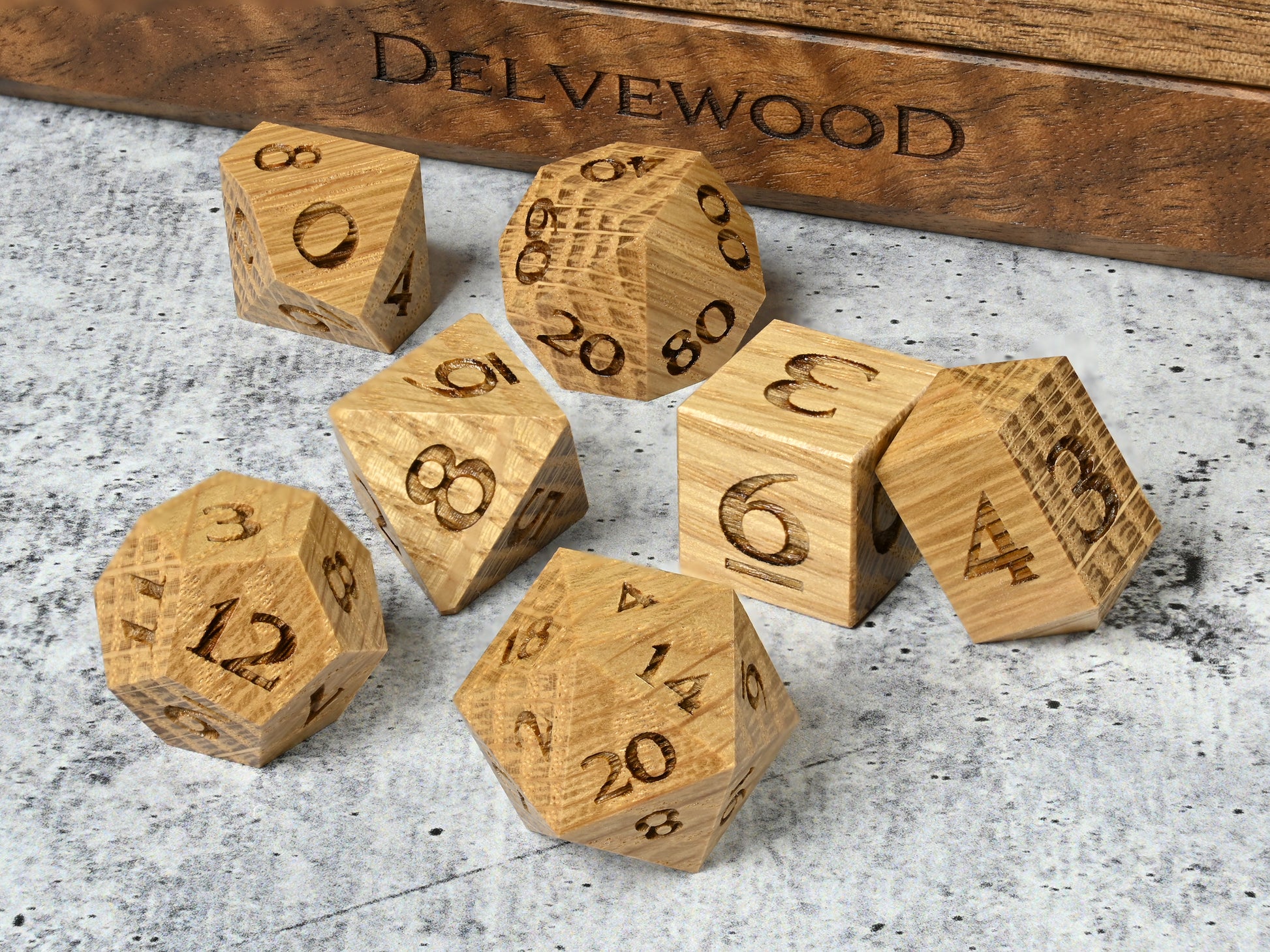 White Oak wood dice set for dnd rpg tabletop gaming in front of Delvewood delver's kit dice box.
